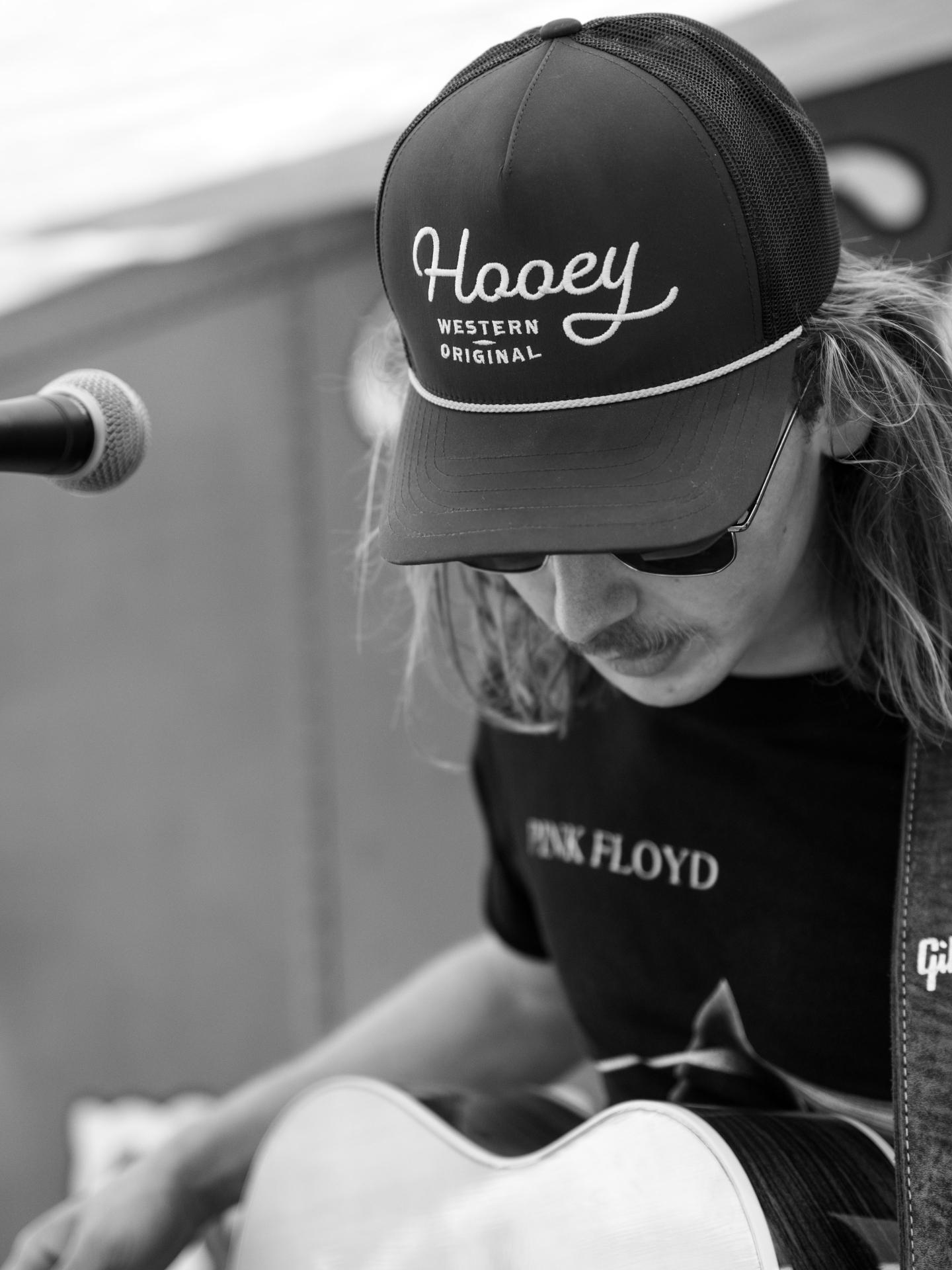 Brandon Stone Jr. singing and playing guitar during a live classic rock and blues performance